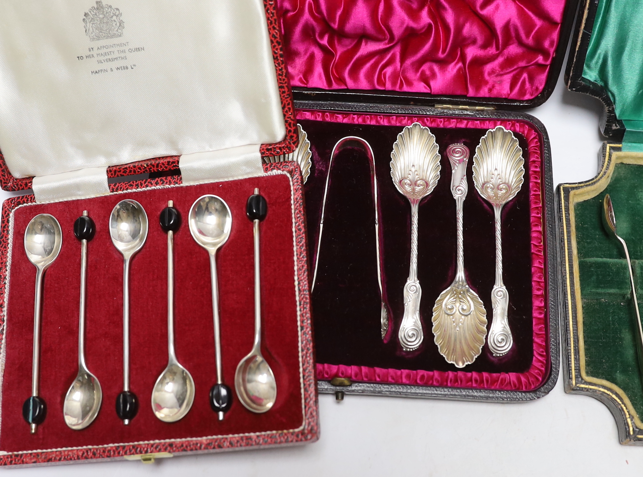 Four assorted sets of six coffee or tea spoons, including two with sugar tongs.